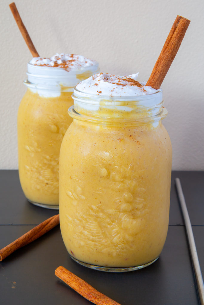 Healthy Pumpkin Spice Smoothies topped with coconut whipped cream