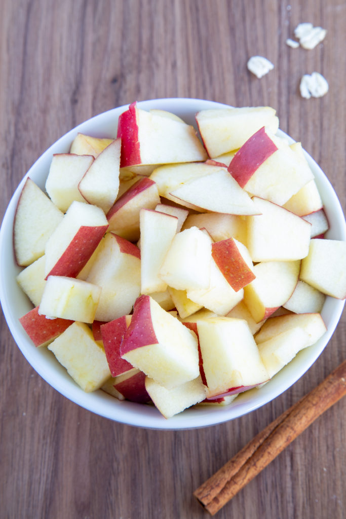 Sliced apples and cinnamon stick