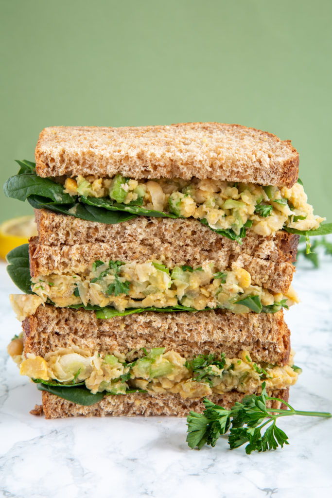 Stacked vegan Chickpea Smash Sandwich on whole grain bread