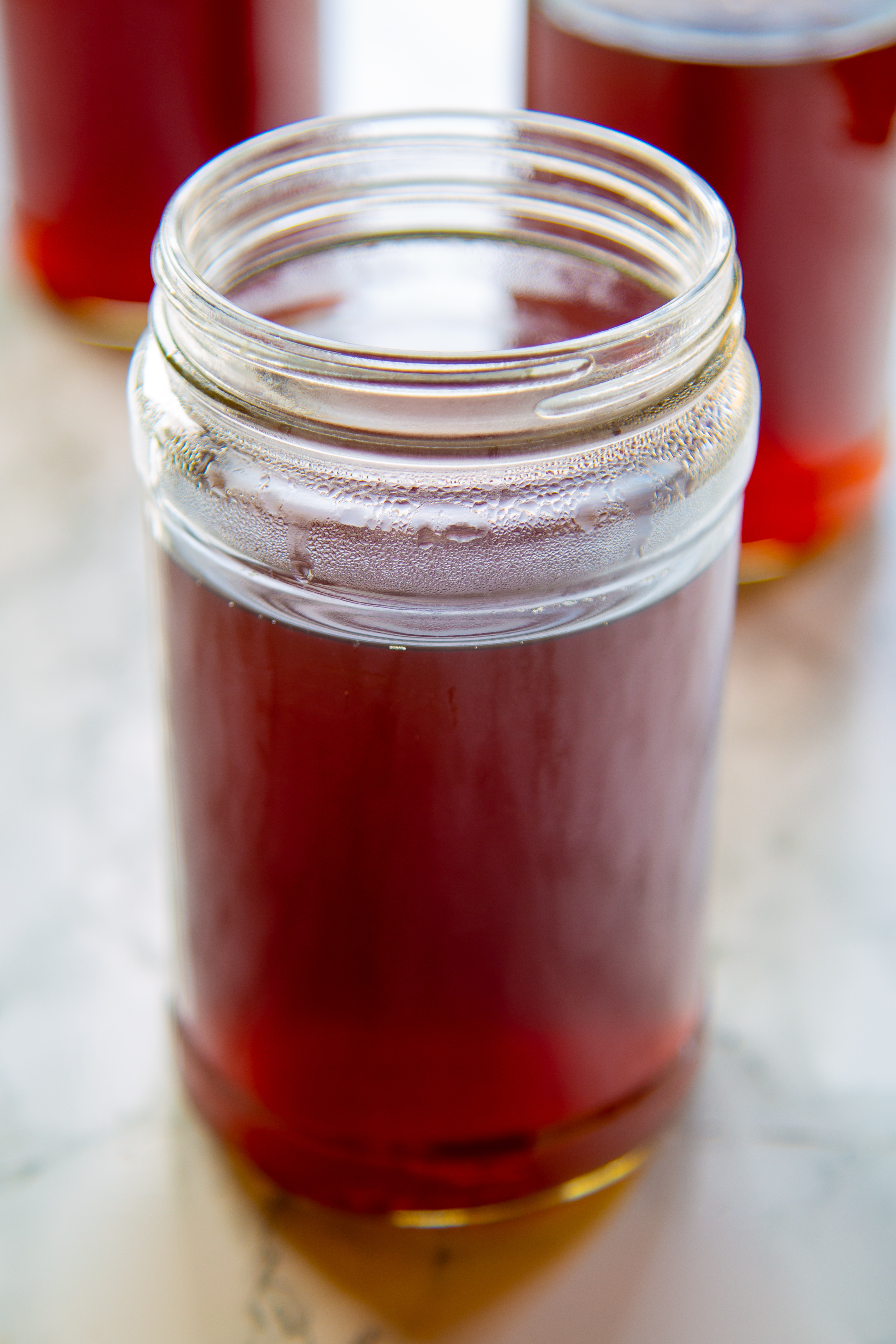 Vegetable broth below shoulder of jar for freezing