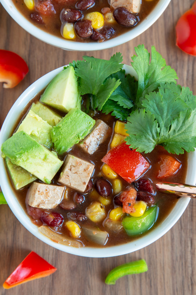 Overhead shot of Vegan Chili topped with avocado and cilantro