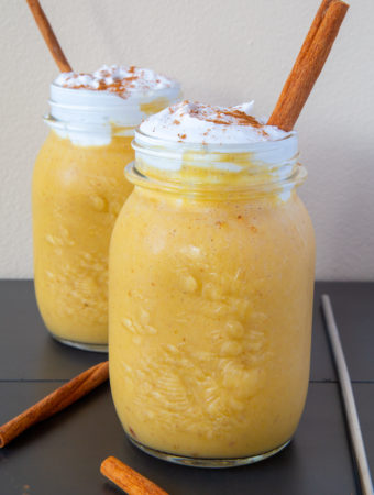 Healthy Pumpkin Spice Smoothies topped with coconut whipped cream